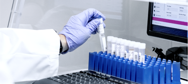Image of somebody handling tubes in a lab environment, indicating Wheeler's research and development services for cell lines, plasmids and more